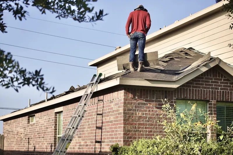 Professional roofer working on a residential roof in Plymouth Hills